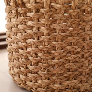 Handmade straw woven flower basket detail, natural plant fiber texture, pastoral home style.