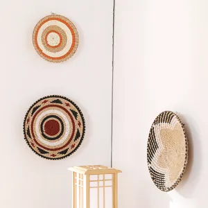 Detail view of Japanese style woven wall decor plates, natural straw hanging art ornaments.