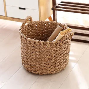 Handmade woven straw storage basket and flower planter pot for home decor and desktop organization.