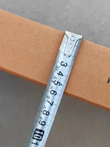Detail shot showing product dimensions with a tape measure, highlighting size and thickness.