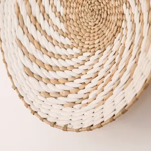 Close-up detail of natural woven wall hanging, white and tan textured circular decor.