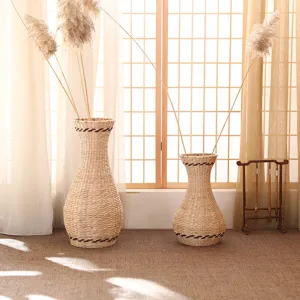 Natural woven straw flower vase and wicker basket set for dried flowers and home decor detail.