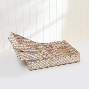 Handmade woven storage basket detail, natural seagrass and white fabric desktop organizer.