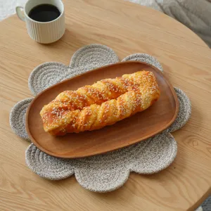 Detail shot of Nordic braided cotton placemat, flower shape, thick heat insulation table mat.