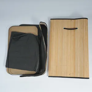 Foldable bamboo storage basket laundry hamper with woven exterior and fabric inner liner.