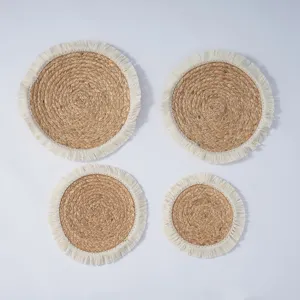 Set of 4 round braided straw placemats and coasters with chic white fringe details for home dining.