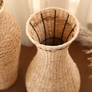 Close-up detail of natural woven straw vase, rustic texture, perfect for dried floral decor.