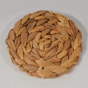 Handmade water hyacinth woven coaster detail showing natural texture, eco-friendly table mat.