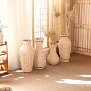 Handcrafted woven straw vase set for dried flowers, rustic home decor detail shot.