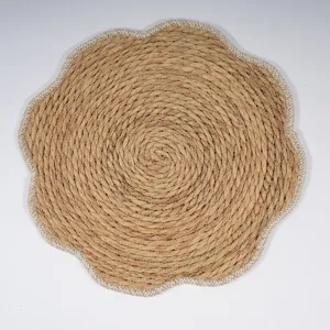 Close-up details of the thick woven cotton rope placemat featuring a chic floral edge.