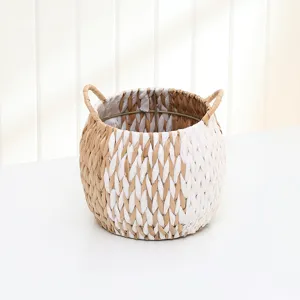 Handmade straw woven storage basket with handles, perfect for home organizing and neat decor.