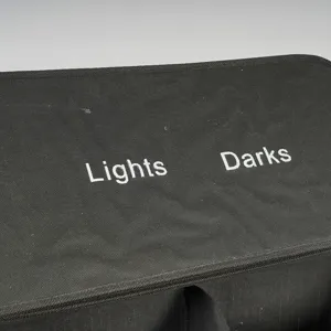 Black fabric laundry sorter detail view with lights and darks text for bedroom home organization.