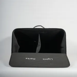 Black double compartment fabric laundry hamper with classification lid for easy clothes sorting.