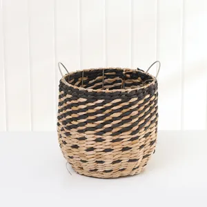 Handwoven straw storage basket with metal frame, black and natural design for home organizing.