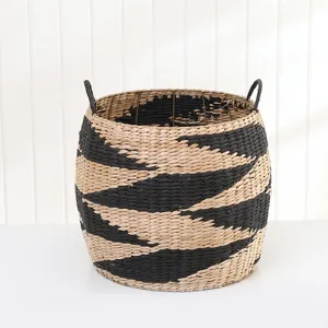 Detailed view of a woven storage basket featuring black and white stripes and handles.