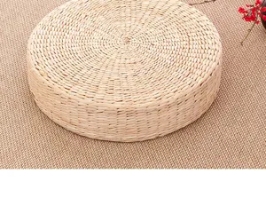 Close up of round straw woven meditation cushion tatami mat for home zen floor seating.