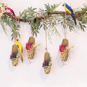 Handmade straw woven parrot toy and hanging home decoration made of natural cattail grass.