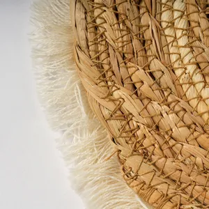 Detailed straw woven placemat with elegant fringe edge, natural heat insulation table pad.