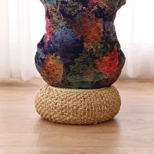 Detailed view of a thick straw woven meditation cushion with natural texture for home use.