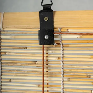Close-up of reed roller blind installation hook, metal clip and durable pull cord detail.