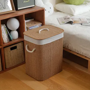 Woven laundry basket with lid and handles, premium bamboo hamper for bedroom storage and organization.