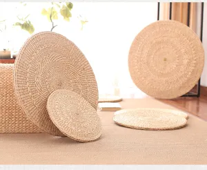 Natural straw woven round cushion tatami pouf detail, thick hand-knitted meditation floor seat pad.