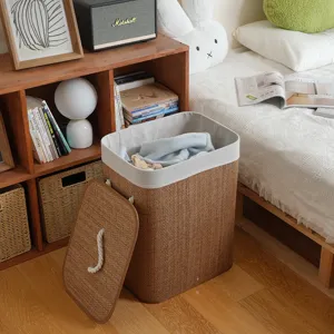 Woven laundry hamper with lid and fabric liner, natural bamboo storage basket for bedroom.
