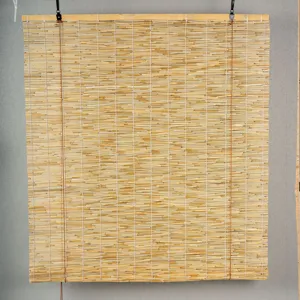 Close-up detail of the natural reed roll blind showing fine bamboo texture and wooden top rail.