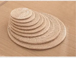 Detailed view of woven straw round cushions stacked together, natural texture for home decor.