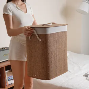 Handmade collapsible bamboo laundry basket with lid and rope handles for home organization.