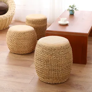 Detailed view of hand-woven straw pouf stool set, natural texture for cozy living room decor.