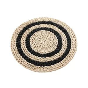 Handmade woven straw placemat round heat insulation pad for daily dining table decor.