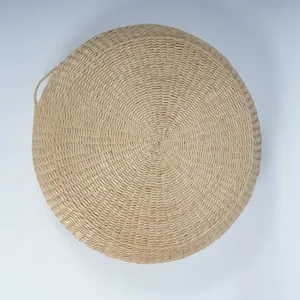 Round straw woven cushion detail, natural plant fiber texture for meditation and yoga.