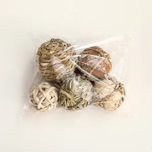 Close-up of assorted natural woven pet chew balls in transparent bag detail view.