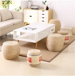 Handmade straw woven meditation pouf detail shot, natural tatami seating for living room.
