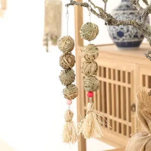 Hanging grass ball toy for parrots and hamsters, natural woven molar chew toy detail view.