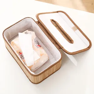 Gedetailleerd overzicht van handgemaakte bamboe tissuedoos open met papier aan de binnenkant.
