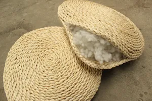 Close-up detail of hand-woven straw tatami floor cushion showing soft inner filling.