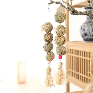 Natural grass ball hanging toy for pet parrot hamster bird chewing and molar fun play detail.