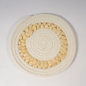 Detailed view of natural straw and corn husk braided placemat, heat resistant kitchen mat.