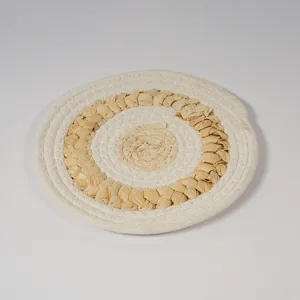 Close-up detail of the woven corn husk and cotton rope placemat, showing textured design.
