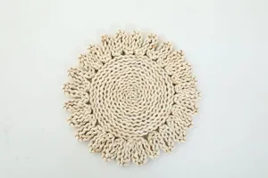 Detalle de mantel individual de paja tejida a mano, diseño rústico de girasol, decorativo natural.