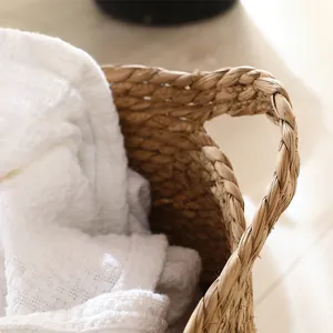 Handcrafted woven straw basket texture detail shot, natural material laundry storage bin closeup.