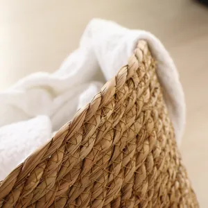 Handmade seagrass laundry basket detail view, woven storage hamper for dirty clothes.