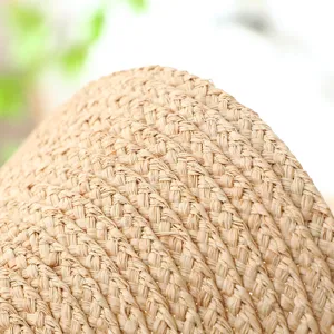 Handmade raffia straw hat material close-up detail view showing natural woven texture.