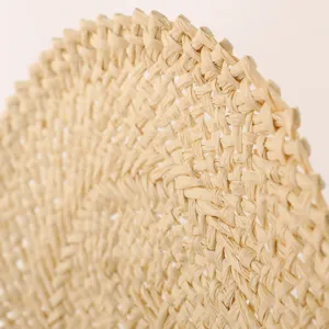 Natural straw woven wall decor detail texture close up, minimalist rustic style home.