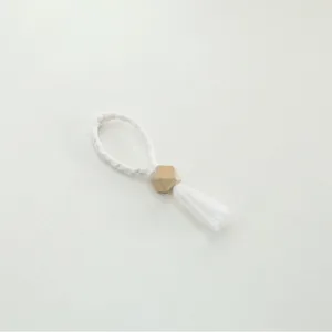 Handmade woven napkin ring with wooden bead and tassel for elegant table decor!
