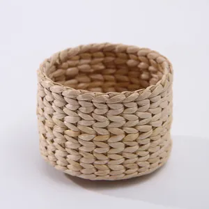 Natural woven straw cup sleeve detail, rustic hand-knotted texture for home vase decor.