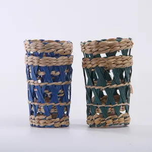 Handmade straw woven cup sleeve and creative vase decoration for home kitchen detail view.