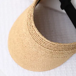 Close-up of straw woven sun visor detail, handmade raffia beach hat texture, summer accessory